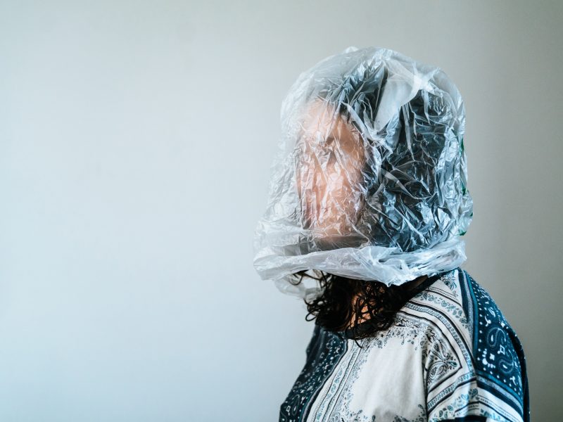 woman with plastic bag over her head